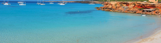 view of Cala Saona Beach, the mediterranean Sea and the typical slipways and fishermen huts, called barraques, in Formentera, Balearic Islands, Spain